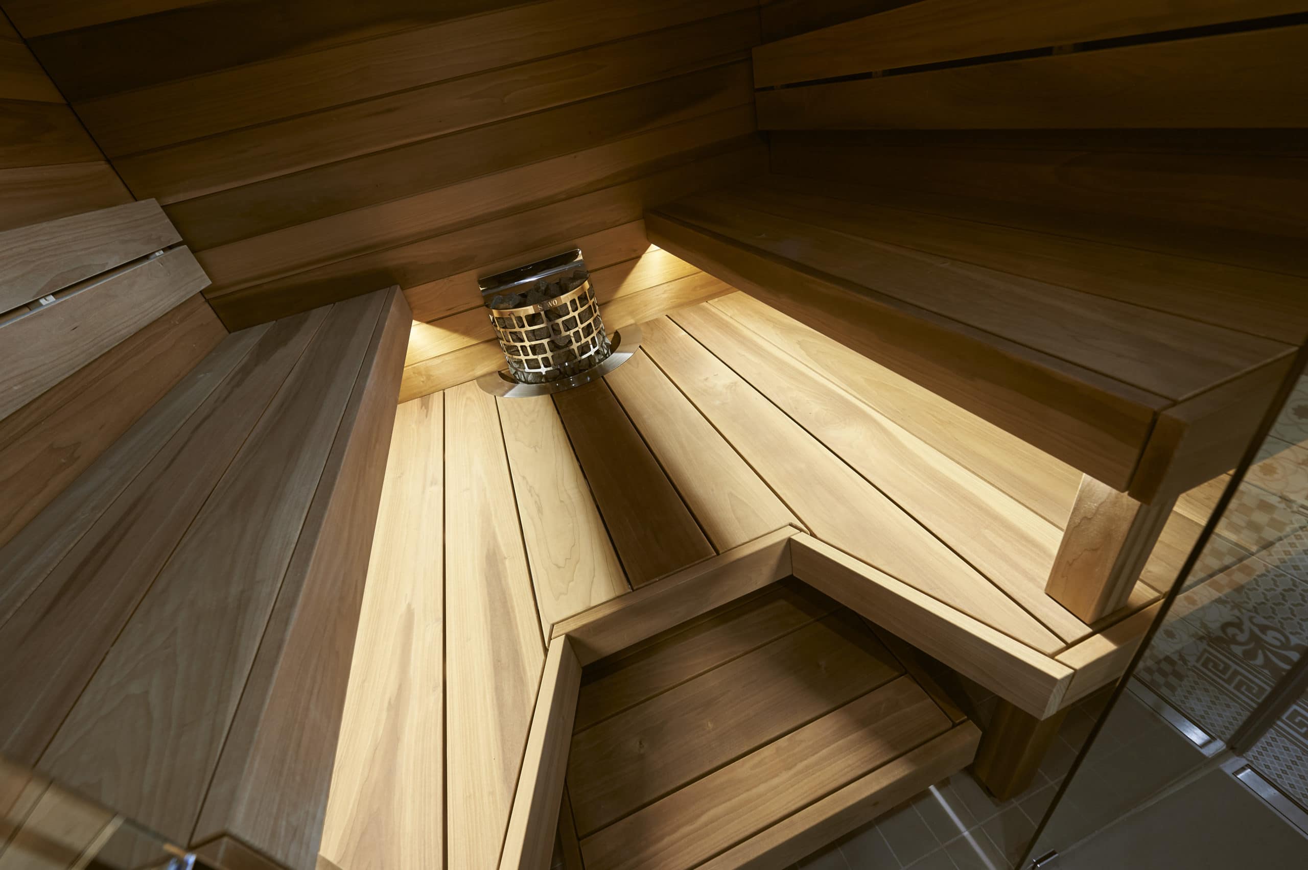 The sauna in the passive house has a facing laude from the Relax collection in wide 185 mm heat-treated magnolia.
